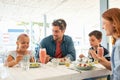 Happy young family enjoying lunch outdoor