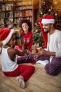 Happy Family exchanging gifts in front of decorated Christmas tree Royalty Free Stock Photo