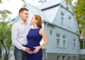 Happy young family expecting child over house Royalty Free Stock Photo