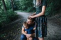 Happy young family father, mother and little son hugging and touching outdoors, playing together in summer park Royalty Free Stock Photo