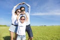 Happy young family forming love shape Royalty Free Stock Photo