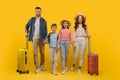 Happy Young Family Of Four Holding Hands And Walking With Suitcases Royalty Free Stock Photo