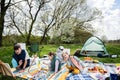 Happy young family, four kids having fun and enjoying outdoor on picnic blanket painting at garden spring park, relaxation Royalty Free Stock Photo