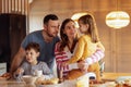 Happy young family has breakfast at the table in the dining room at home Royalty Free Stock Photo