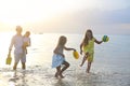 Happy young family have fun on beach run and jump Royalty Free Stock Photo