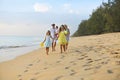 Happy young family have fun on beach run and jump Royalty Free Stock Photo