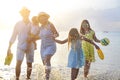 Happy young family have fun on beach run and jump Royalty Free Stock Photo