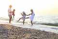 Happy young family have fun on beach run and jump Royalty Free Stock Photo