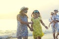 Happy young family have fun on beach run and jump Royalty Free Stock Photo