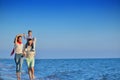 Happy young family have fun on beach run and jump at sunset Royalty Free Stock Photo