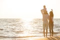 Happy young family have fun on beach run and jump at sunset Royalty Free Stock Photo