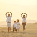 Happy young family have fun on beach at sunset Royalty Free Stock Photo