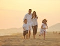 Happy young family have fun on beach at sunset Royalty Free Stock Photo