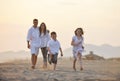 Happy young family have fun on beach at sunset Royalty Free Stock Photo