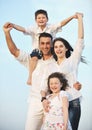 Happy young family have fun on beach at sunset Royalty Free Stock Photo