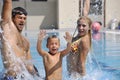 Happy young family have fun on swimming pool Royalty Free Stock Photo