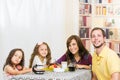 Happy young family having breakfast together Royalty Free Stock Photo