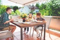 Happy young family having fun during breakfast on terrasse at ho Royalty Free Stock Photo