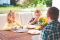 Happy young family having fun during breakfast on terrasse at ho Royalty Free Stock Photo