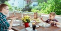 Happy young family having fun during breakfast on terrasse at home Royalty Free Stock Photo