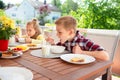 Happy young family having fun during breakfast on terrasse at ho Royalty Free Stock Photo