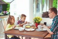 Happy young family having fun during breakfast on terrasse at ho Royalty Free Stock Photo