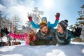 Young family having fun on fresh snow on winter vacation Royalty Free Stock Photo
