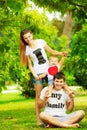 Happy young family is having fun in the green summer park outdoors on a sunny day. Mother, father and their little baby-boy are w Royalty Free Stock Photo