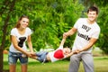 Happy young family is having fun in the green summer park outdoors on a sunny day. Mother, father and their little baby-boy are w Royalty Free Stock Photo