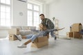 Happy young family having fun in the living room of their new home on moving day Royalty Free Stock Photo