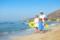 Happy young family having fun running on beach at sunset. Family Royalty Free Stock Photo