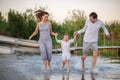 Happy young family having fun running on water at the beach Royalty Free Stock Photo