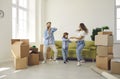 Happy family having fun in room with unpacked boxes in their new home on moving day Royalty Free Stock Photo