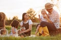 Happy young family having lunch at summer garden party. Mother, father and two kids enjoy spending time together on Royalty Free Stock Photo