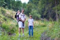 Happy young family hiking in beautiful autumn forest Royalty Free Stock Photo