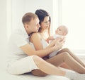 Happy young family at home in white room near window, parents Royalty Free Stock Photo