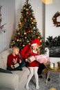 Happy young family with kids having fun celebrating christmas. Christmas time at home. Royalty Free Stock Photo