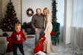 Happy young family with kids having fun celebrating christmas. Christmas time at home. Royalty Free Stock Photo