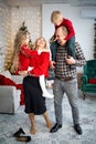 Happy young family with kids having fun celebrating christmas. Christmas time at home. Royalty Free Stock Photo