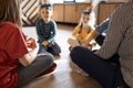 Happy young family with kids playing a card game at home sitting on the floor Royalty Free Stock Photo