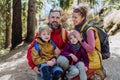 Happy young family with little children, resting near lake in mountains. Royalty Free Stock Photo