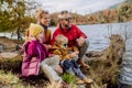 Happy young family with little children, resting near lake in mountains. Royalty Free Stock Photo