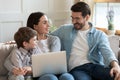 Young family with small son using laptop at home Royalty Free Stock Photo