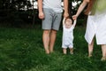 Happy young family, mom, dad and baby son spending time together outdoors in summer green garden. parents holding their Royalty Free Stock Photo