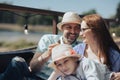 Happy young family- mom,dad and teenage girl daughter traveling together and relaxing in street cafe Royalty Free Stock Photo