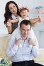 Beautiful couple with a small daughter home the portrait Royalty Free Stock Photo