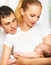 Happy young family of mother, father and newborn baby in their a Royalty Free Stock Photo