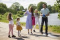 Happy young family- mother,father and three children daughter girls walking on city sidewalk Royalty Free Stock Photo