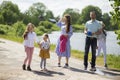 Happy young family- mother,father and three children daughter girls walking on city sidewalk Royalty Free Stock Photo