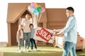 happy young family moving into new cardbord house Royalty Free Stock Photo